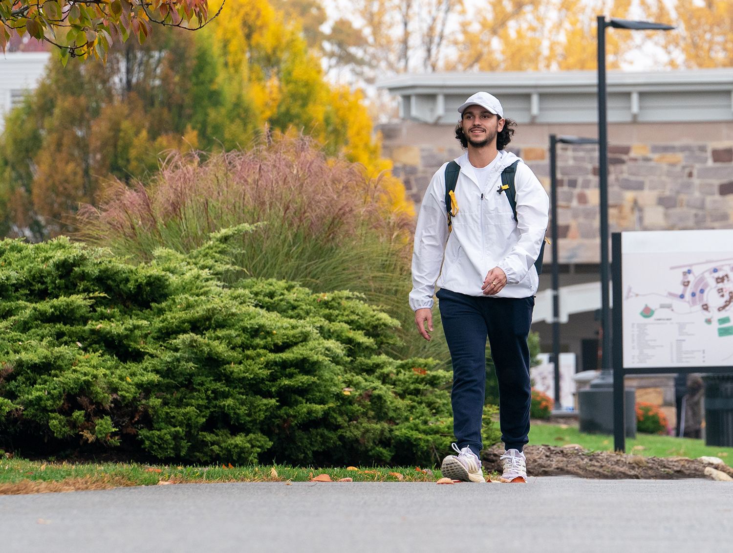 Image of male student walking on campus